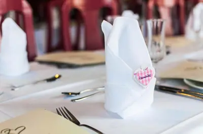 a table with a white paper bag with a heart on it at Dolmsundet Hotell Hitra in Melandsjøen