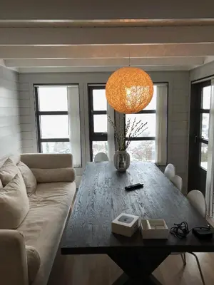 a living room with a table and a couch at Voss Hytte/Cabin in Skulestadmo