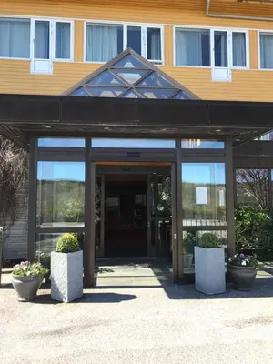 an entrance to a building with a glass door at Alver Hotel in Alversund