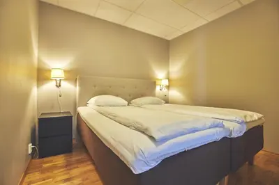a bedroom with a large bed with two pillows at Hotel Frøya in Sistranda
