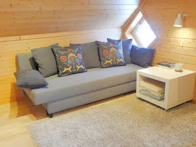 a couch with pillows and a table in a room at Fully equipped flat, 2 bedrooms, FREE car parking. in Trondheim