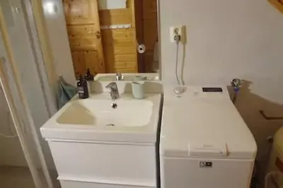 a bathroom with a white sink and a mirror at Fully equipped flat, 2 bedrooms, FREE car parking. in Trondheim