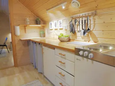 a kitchen with wooden walls and a counter top at Fully equipped flat, 2 bedrooms, FREE car parking. in Trondheim