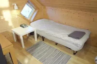 a small room with a bed and a table at Fully equipped flat, 2 bedrooms, FREE car parking. in Trondheim