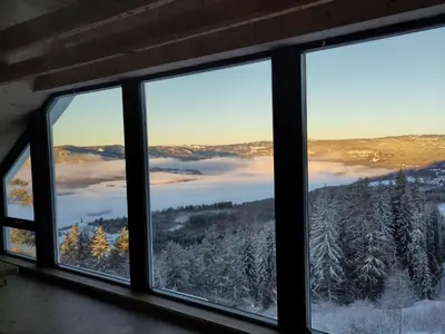 a window with a view of a snowy mountain at Granum Gård in Fluberg