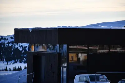 a building with a van parked in front of it at Pellestova Hotell Hafjell in Hafjell