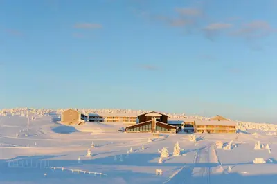 a snow covered town with houses and buildings at Pellestova Hotell Hafjell in Hafjell
