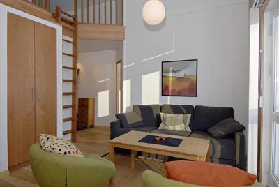 a living room with a couch and a table at Vossestrand Hotel and Apartments in Myrkdalen