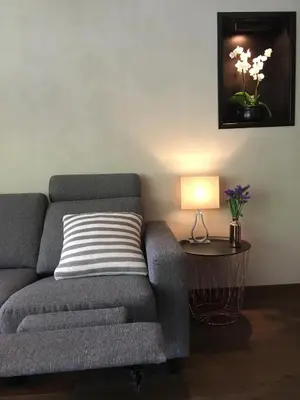 a living room with a couch and a table with a lamp at Olden apartments 1 in Olden