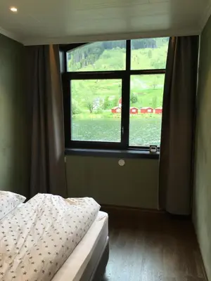 a bedroom with a window with a bed and a bed sidx sidx sidx at Olden apartments 1 in Olden