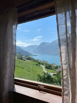 a window with a view of a lake and mountains at Kvam - Stegastein in Aurland
