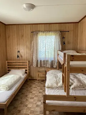 a bedroom with two bunk beds and a window at Kvam - Stegastein in Aurland