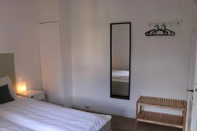a bedroom with a bed and a mirror on the wall at Valldal Gjestgiveri in Valldal