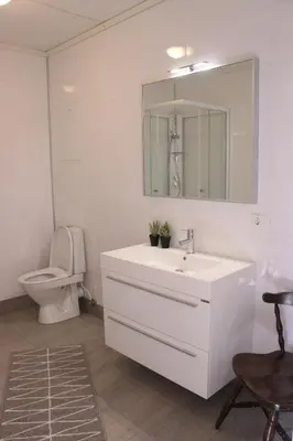 a bathroom with a white sink and a toilet at Valldal Gjestgiveri in Valldal