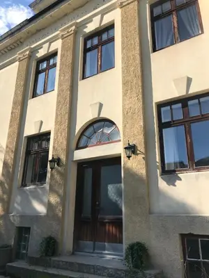 a building with large glass doors and windows at Valldal Gjestgiveri in Valldal