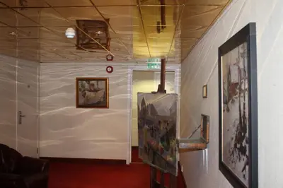 a hallway with paintings on the walls of a room at Kløver Hotel in Sauda