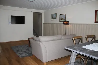 a living room with a couch and a table at Kløver Hotel in Sauda