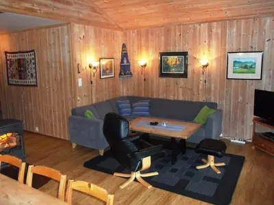 a living room with a couch and a table at Hogstul Hytter - Knatten - 3 Bedroom Cottage in Tuddal