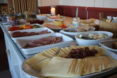 a buffet with many plates of food on a table at Nordseter Apartments in Lillehammer