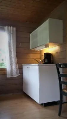 a kitchen with a white counter and a window at Folven Adventure Camp in Hjelle