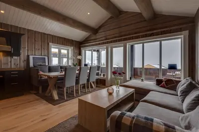 a living room with a couch and a table at Tinden Grendehytte in Beitostøl
