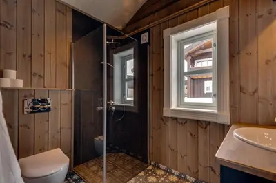 a bathroom with a shower and a toilet and a sink at Tinden Grendehytte in Beitostøl