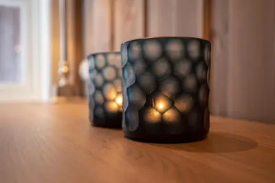 two cups sitting on top of a wooden table at Tinden Grendehytte in Beitostøl