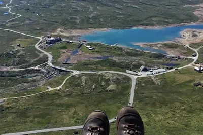 a view of the feet of a person flying over a road at Tinden Grendehytte in Beitostøl