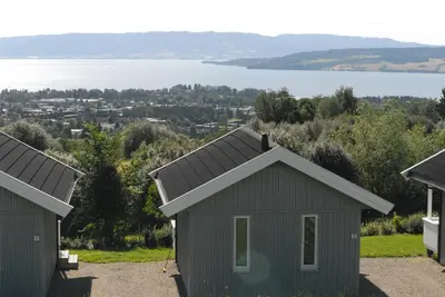 a small house with a view of a lake at Hedmarktoppen in Hamar