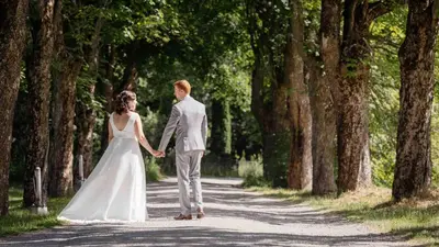 a bride and groom walking down a road at Thorbjørnrud Hotell in Jevnaker