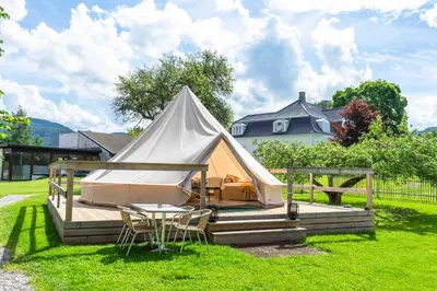 a tent with chairs and a table in a yard at Thorbjørnrud Hotell in Jevnaker