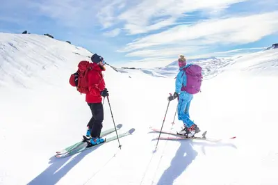 two people on skis on a snow covered mountain at Storestølen Fjellhotell in Hovet