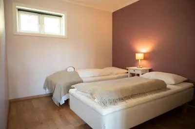 two beds in a room with a window at Storestølen Fjellhotell in Hovet