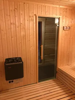 a inside view of a sauna with a door open at Camp Dronningkrona in Ålvundeid
