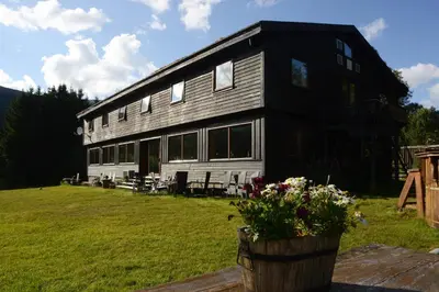 a large black and white house with a yard at Voss Lodge Rongastovo in Vossevangen