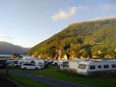 a group of rvs parked next to a mountain at Kyrping Camping in Kyrping