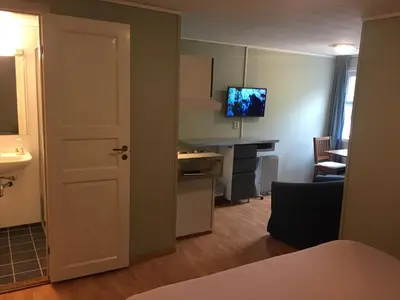 an open door to a room with a kitchen and a desk at Kyrping Camping in Kyrping