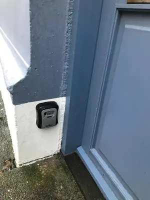 a door with a box on the side of a building at Ålesund downtown loft room with shared bathroom in Ålesund
