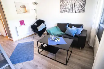 a living room with a couch and a table at Maristova apartment 110 in Filefjell