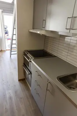 a kitchen with a sink and a stove top oven at Maristova apartment 110 in Filefjell