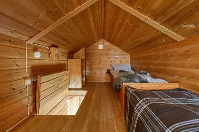 a log cabin with a bed in a room at Nordseter Hytter in Nordseter