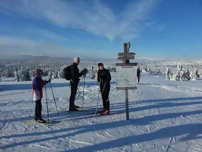 a group of people standing at the top of a ski slope at Nordseter Hytter in Nordseter