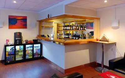 a bar in a room with a lot of alcohol at Sentrum Hotel in Nordfjordeid