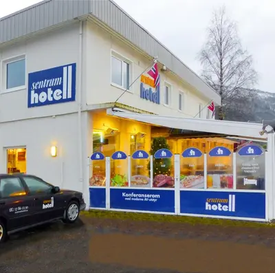 a store with a car parked in front of it at Sentrum Hotel in Nordfjordeid