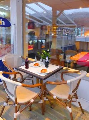 a table and chairs with plates of food on it at Sentrum Hotel in Nordfjordeid