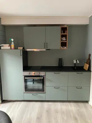 a kitchen with white cabinets and an oven at Oppdal Alpintun in Oppdal