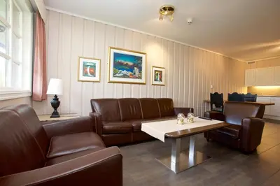 a living room with a couch and a table at Fanitullen Apartments in Hemsedal