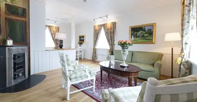 a living room with a couch and a table at Hovde Gård in Brekstad