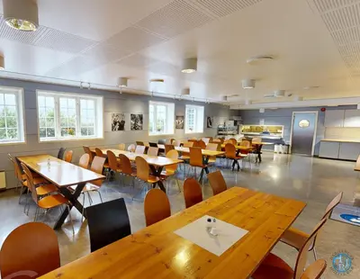 a dining room with wooden tables and chairs at Hardanger Hostel B&B in Lofthus