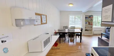 a kitchen and dining room with a table and chairs at Hardanger Hostel B&B in Lofthus